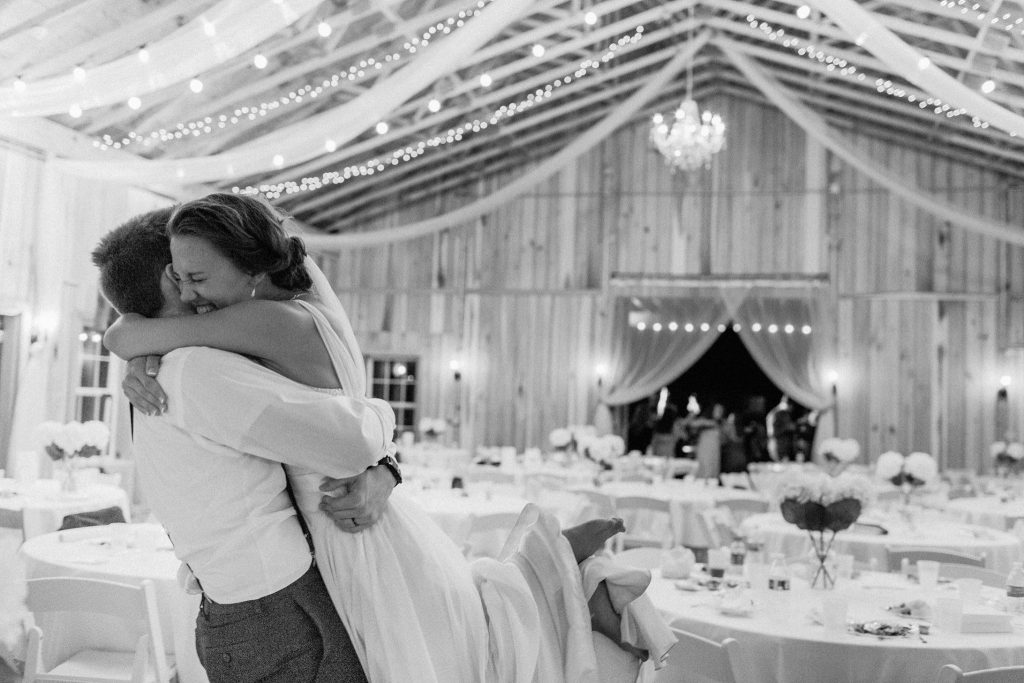 Bride and groom hug at Indiana barn wedding venue The Barn at Hawks Point