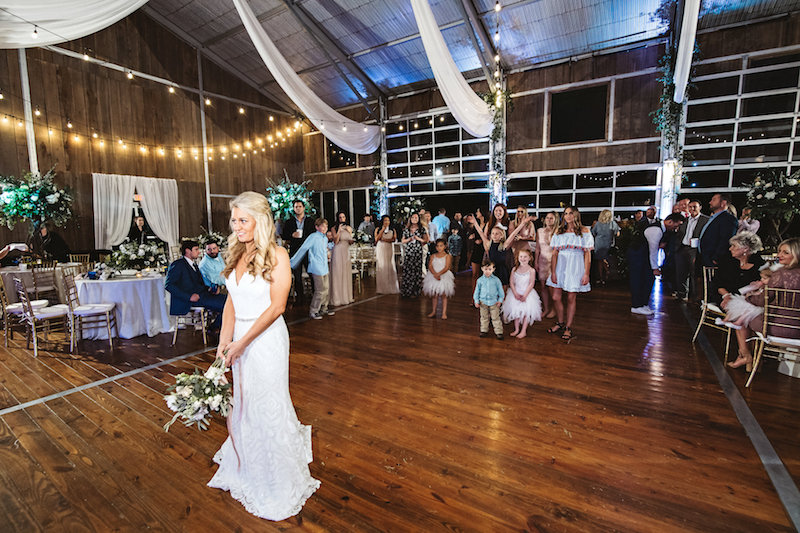 Wedding bouquet toss at a barn wedding, Spring Creek Ranch in Tennessee