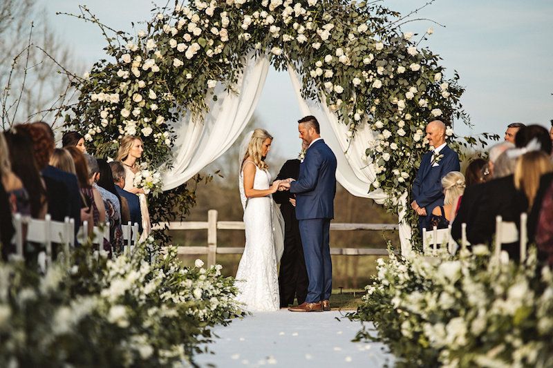 Rustic outdoor wedding ceremony at barn wedding venue Spring Creek Ranch in Tennessee