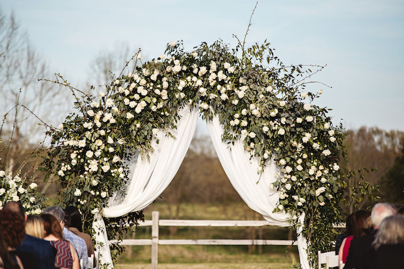 Rustic ceremony flowers at a rustic outdoor wedding ceremony at Spring Creek Ranch in Tennessee