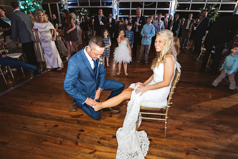 Wedding garter toss at a barn wedding venue, Spring Creek Ranch in Tennessee