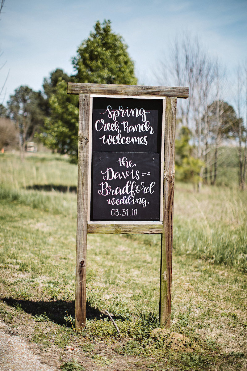 Rustic wedding welcome sign at barn wedding venue Spring Creek Ranch in Tennessee