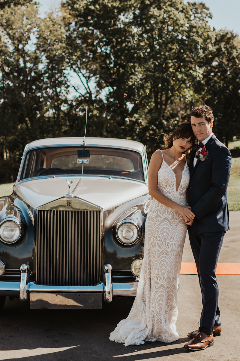 Rustic wedding bride and groom with vintage car